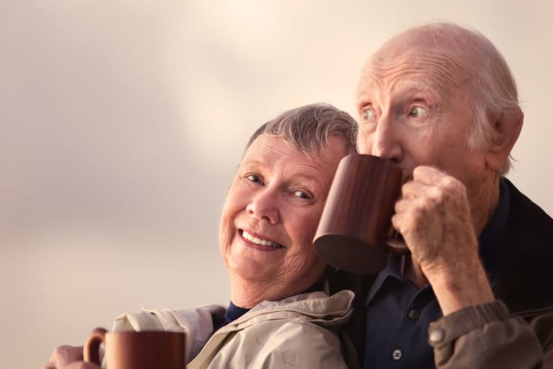 Two Dental Implant Patients Smiling And Drinking Coffee